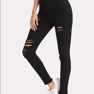 Distressed black skinny jeans